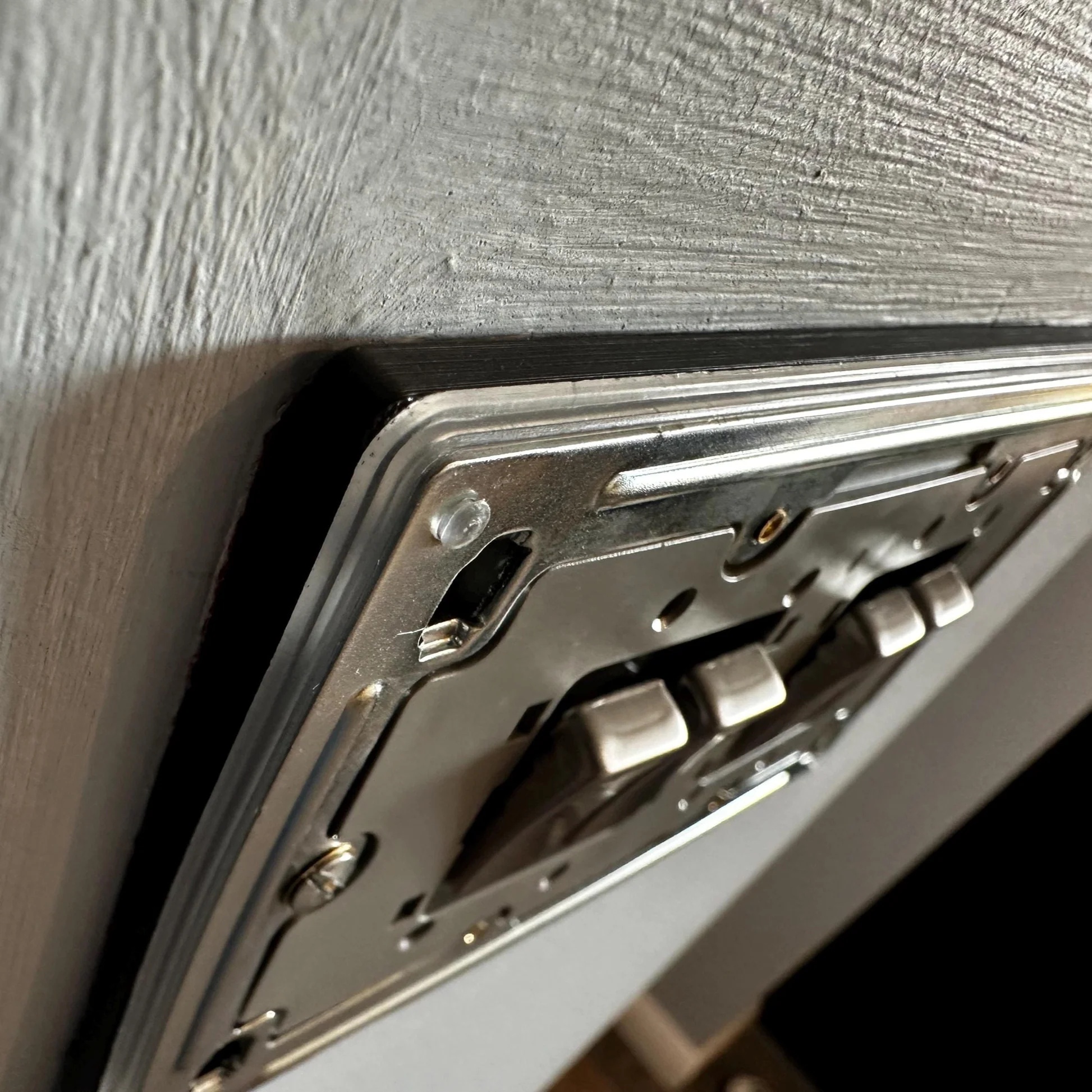A newly installed socket spacer behind a faceplate, before decorative cover replaced